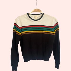 Cute sweater, not thick or thin.  Feels nice on, soft type material.